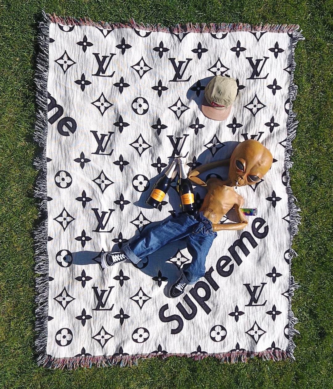 Lil Mayo spotted on Louis Vuitton & Supreme collaborative blanket